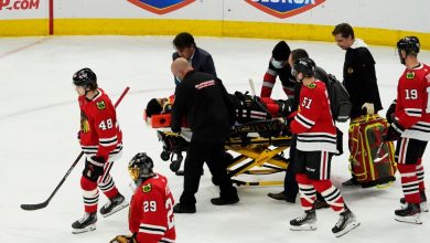 Chicago Blackhawks' Jujhar Khaira comes off the field on a stretcher after being hit by New York Rangers' Jacob Trouba