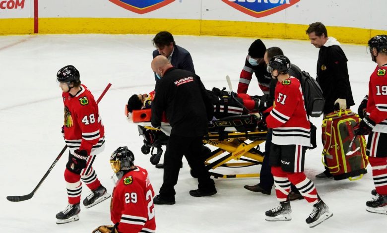 Chicago Blackhawks' Jujhar Khaira comes off the field on a stretcher after being hit by New York Rangers' Jacob Trouba