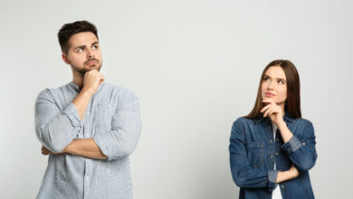Pensive man and woman on light background.