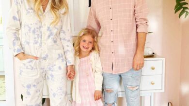 mom, daughter, and dad in their home in pastel clothing
