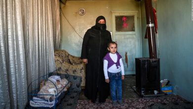 Syrian refugee Areej Beidun, 6, (R) and her grandmother Nadesa Beidun pose in Gaziantep, southeastern Turkey, on February 26, 2021.