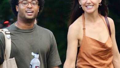 Katie Holmes and Bobby Wooten III both smiling while taking a romantic walk