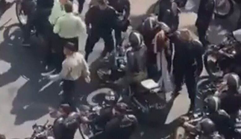 Iranian police looking into incident involving woman surrounded by officers in street