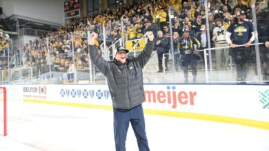 Michigan football team celebrates victory over Ohio State in hockey game