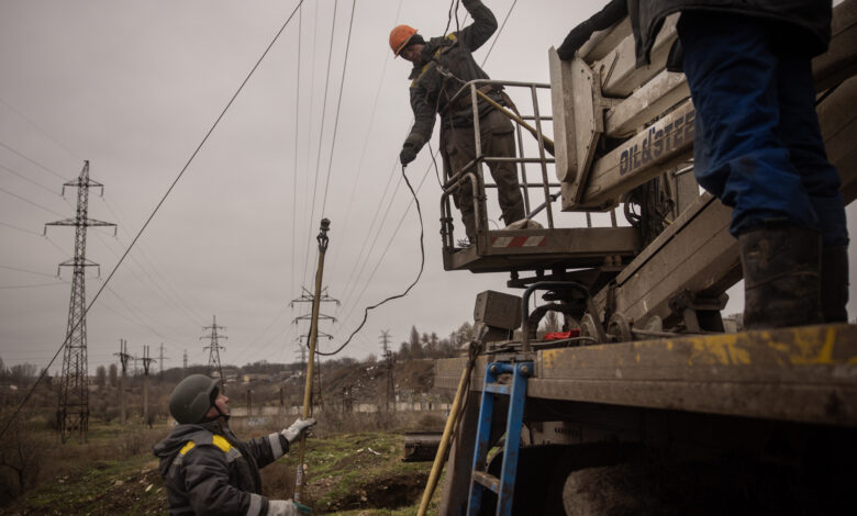 Electricity workers fix a destroyed high voltage power line on Thursday in Kherson, Ukraine.