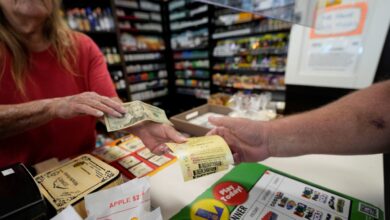 Cashier Rosemary Probst sells tickets for the Mega Millions lottery at the Save 'N Time convenience store in Harahan, La., Wednesday, July 26, 2023. (AP Photo/Gerald Herbert)