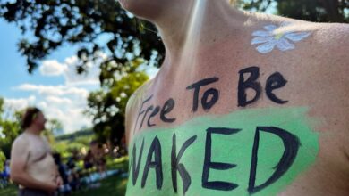 A rider poses at the start of the Philly Naked Bike Ride in Philadelphia on Aug. 26, 2023. (AP Photo/Tassanee Vejpongsa)
